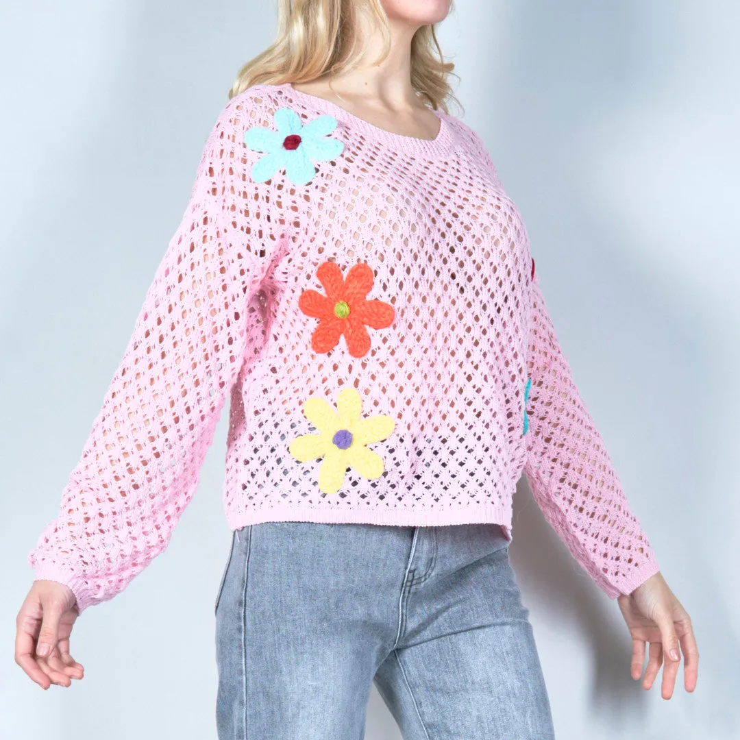 Open-knit sweater with colorful floral applique wholesale